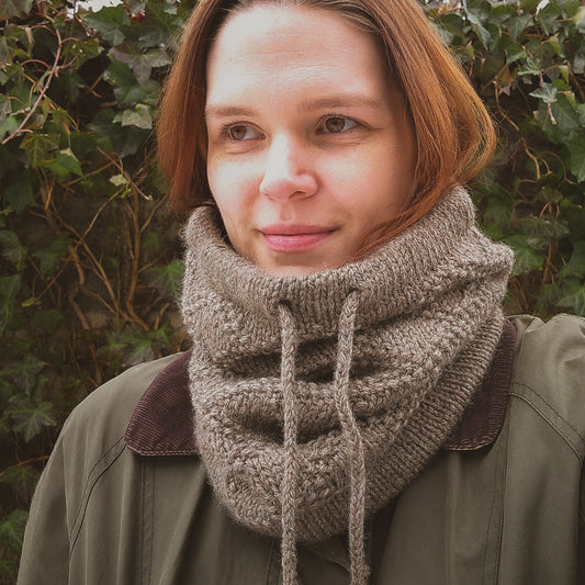 jules wearing a grey textured knit cowl with a drawstring