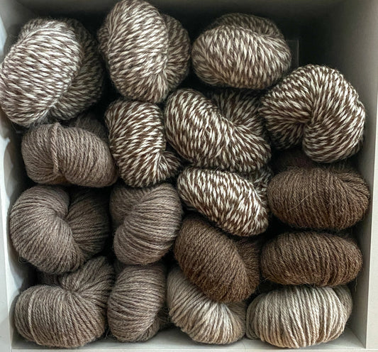a cubby full of neutral-colored, undyed wool yarn