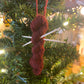 Red mini yarn skein and knitting needles ornament on a Christmas tree