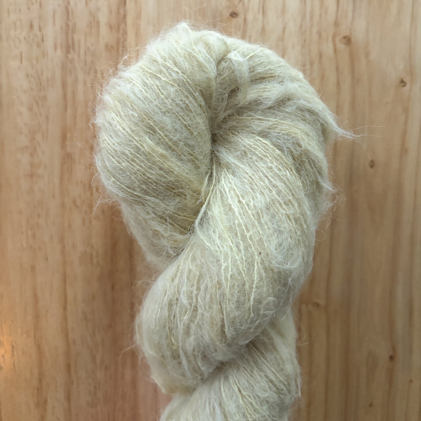 skein of light green yarn on a wood surface