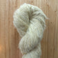 skein of light green yarn on a wood surface